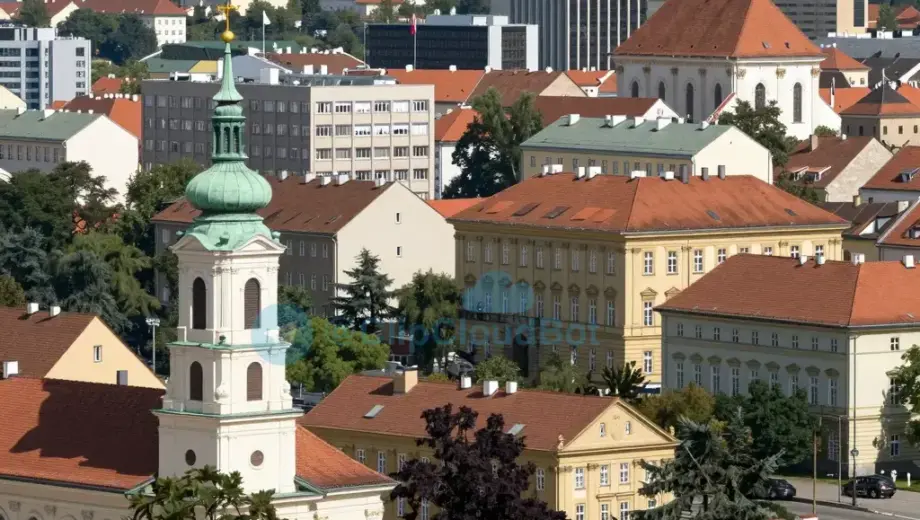A scenic view of Miskolc, Hungary, showing the city skyline with prominent buildings and landmarks, nestled in the Northern (Észak) region, with clear skies and natural daylight, possibly including the Bükk Mountains in the background