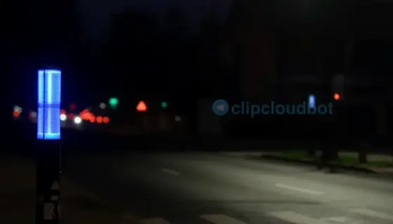 A high-quality, photorealistic night scene in Miskolc, Hungary, featuring a glowing blue flashing lamp on a quiet urban street, with soft ambient light reflecting on wet pavement, distant city lights blurred in the background, and a subtle sense of motion from the flashing light — no people, no text, no signs, no vehicles, just atmosphere and light