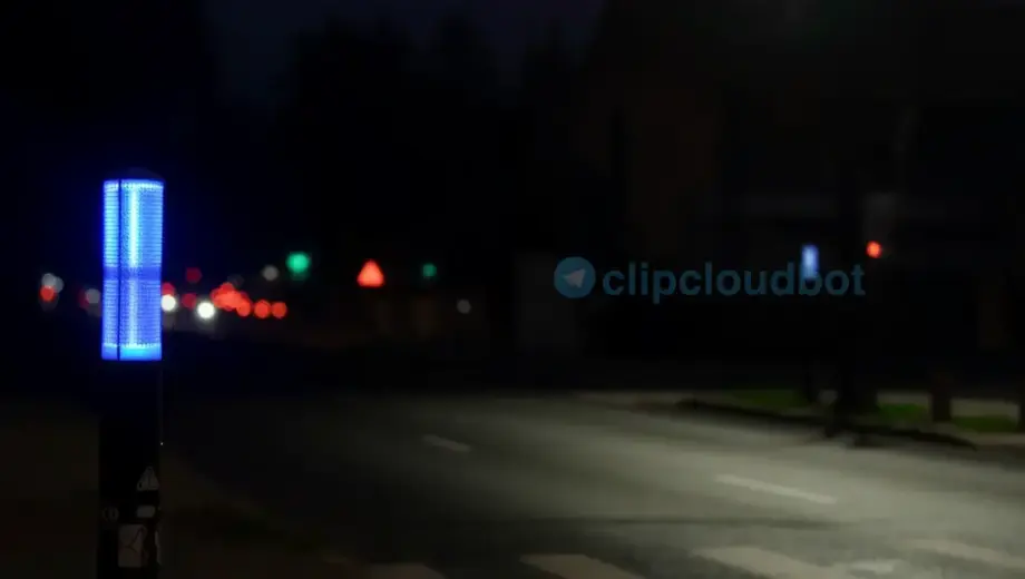 A high-quality, photorealistic night scene in Miskolc, Hungary, featuring a glowing blue flashing lamp on a quiet urban street, with soft ambient light reflecting on wet pavement, distant city lights blurred in the background, and a subtle sense of motion from the flashing light — no people, no text, no signs, no vehicles, just atmosphere and light