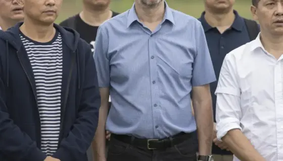 A group of people standing together in a natural outdoor setting, possibly a park or countryside, with a sense of unexpected arrival or gathering, depicting Dr. Zima András and his companions in a moment of serendipitous meeting, with expressive faces and casual yet thoughtful attire, conveying a narrative moment of connection and surprise