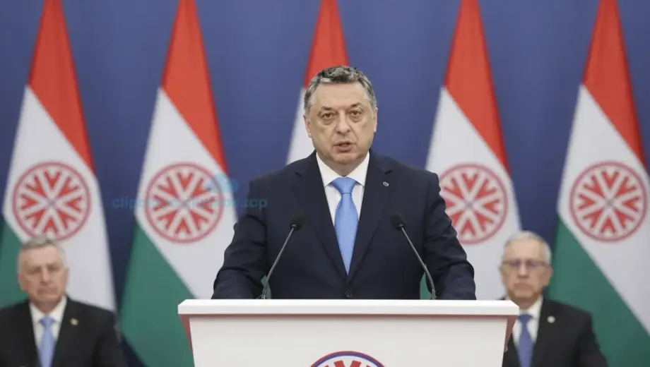 Prime Minister Viktor Orbán speaking at a Fidesz party congress, standing at a podium with Hungarian flags and party banners behind him, audience of supporters in the background, formal political setting, dignified expression