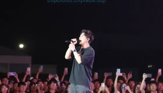 A dramatic concert stage at night with a large crowd of people, a central performer singing passionately into a microphone, colorful stage lights illuminating the scene, and a dark sky above