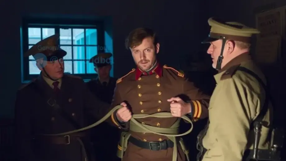 A historical scene depicting a man in 19th-century military uniform being tied up by soldiers in a dimly lit room, with a barred window and a wooden chair visible in the background, conveying a serious and tense atmosphere