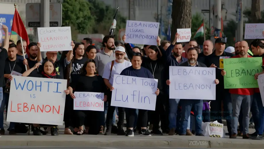 A tense protest scene in Palestine featuring diverse demonstrators holding signs against terrorism organizations, set against a backdrop of urban streets with subtle references to Lebanon and Israel, rendered in a realistic style emphasizing emotional intensity and political context