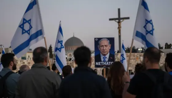 A symbolic image representing Israeli anxiety, Netanyahu's campaign, and anti-Christian attacks: a tense urban scene in Jerusalem at dusk, with shadowy figures of political protesters holding Israeli flags, a distant silhouette of Netanyahu on a campaign poster with a concerned expression, and subtle signs of vandalism on a Christian cross or church symbol in the background — all rendered in a somber, realistic tone with muted colors and dramatic lighting to convey unease and political tension